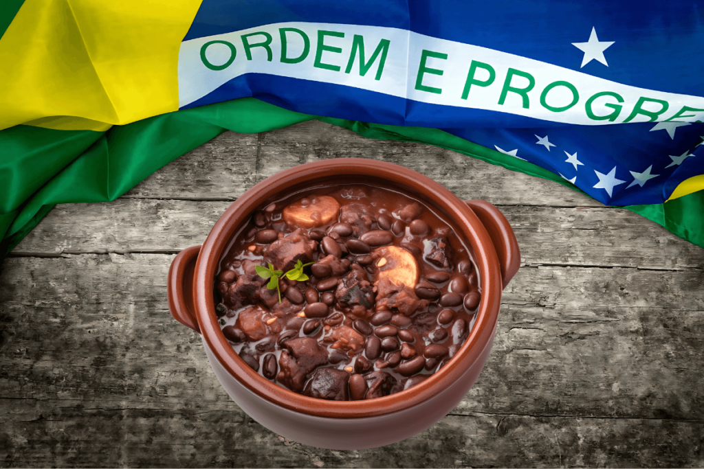 Imagem de feijoada em panela de barro com a bandeira do Brasil ao fundo. Prato típico da culinária brasileira, comida tradicional do Brasil, iguaria brasileira completa.
